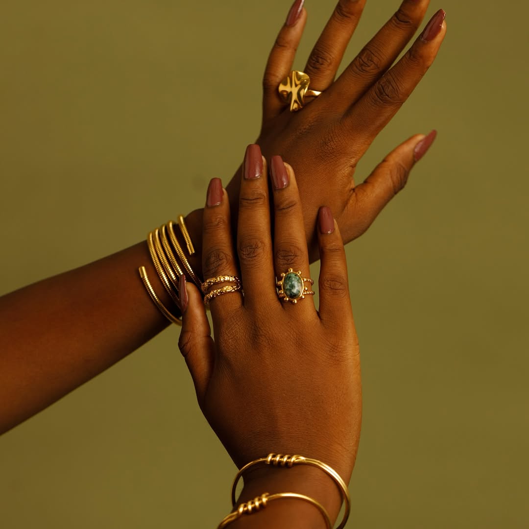 Woman who wears piles of golden gold clogs and bracelets
